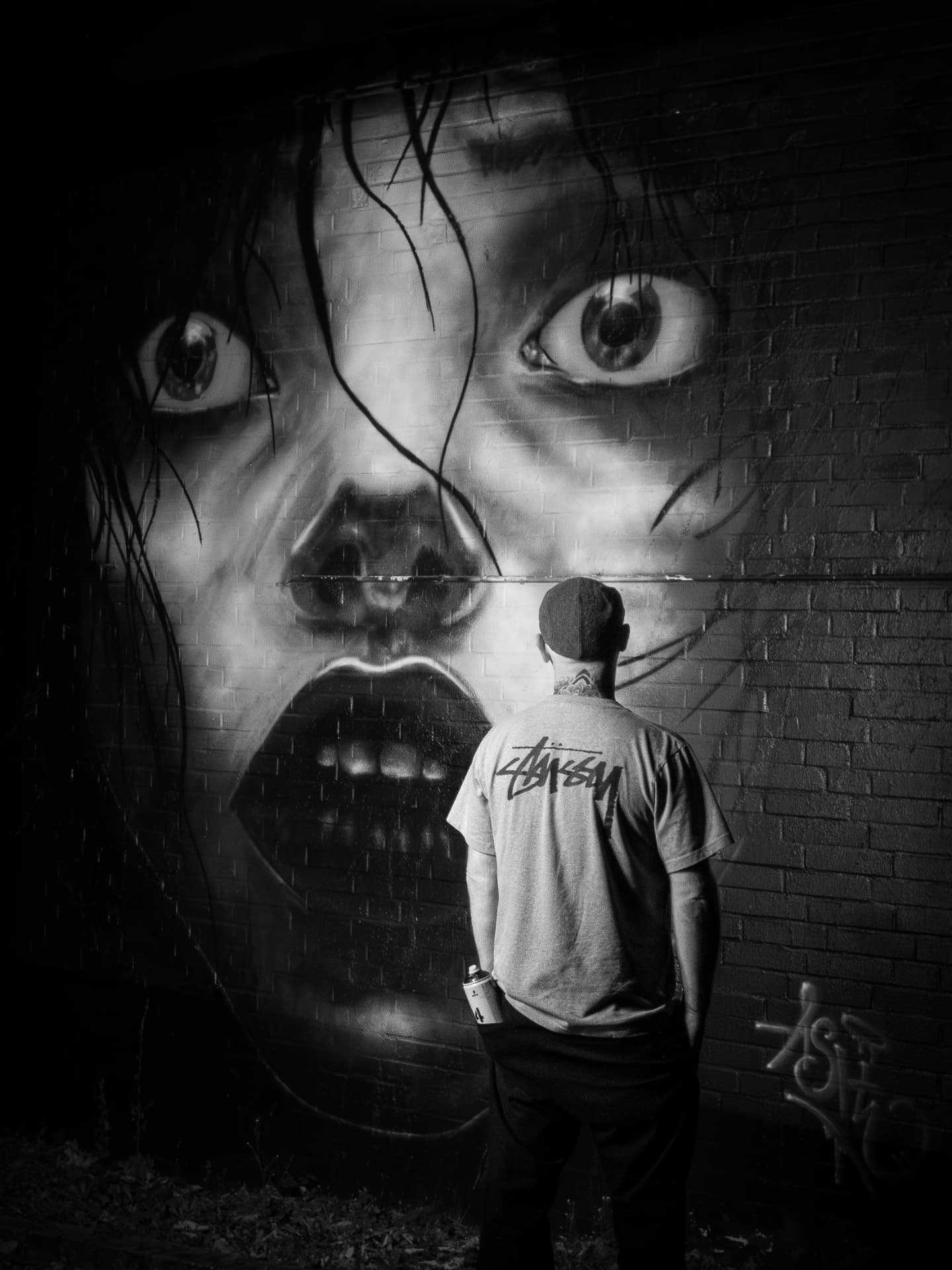 ASHN vor seinem großformatigen Schwarz-Weiß-Gesichtsmural
